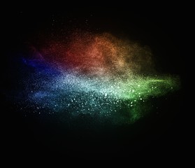 Colourful powder exploding isolated on black