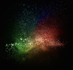 Colourful powder exploding isolated on black