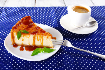 Cheese cake and cup of coffee on polka dot tablecloth