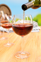 Red wine pouring into wine glass, close-up