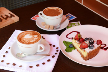 Cup of coffee with cute drawing in cafe