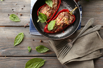 Delicious stuffed peppers in frying pan on table close-up