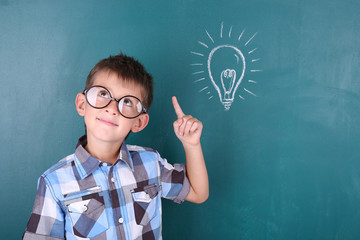 Schoolboy at blackboard in classroom