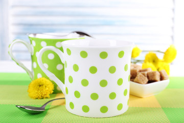 Two polka dot cups with sugar and wildflowers