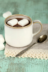 Hot chocolate with marshmallows in mug, on wooden background