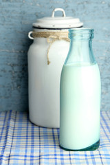 Retro still life with tasty rustic milk, on table