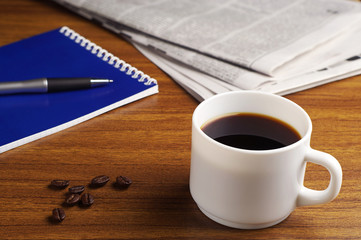 Coffee, newspaper and notepad
