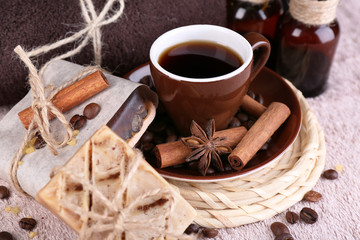 Fototapeta na wymiar Cup with coffee drink, soap with coffee beans and spa treatment