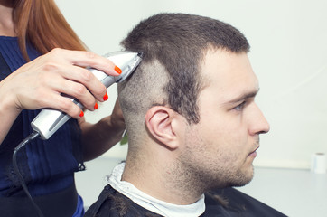 young man in a barber shaved shorn