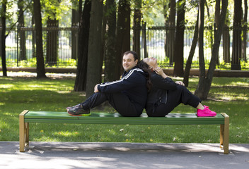 man and woman walking in the park