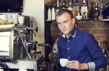 young man working as a bartender in a nightclub bar
