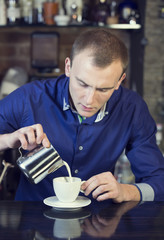 young man working as a bartender in a nightclub bar