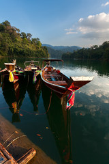 Obraz premium national boats on the lake in the jungle on a sunset