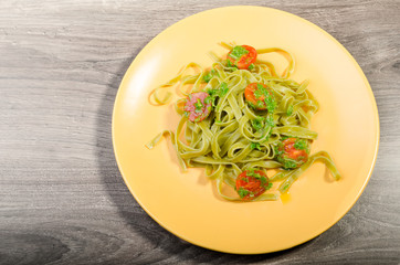 Pasta with basil pesto and pine nuts, cherry tomatoes