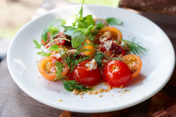 Simple appetizer with cherry tomatoes and smoked duck fillet