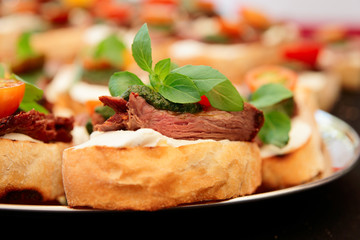 Bruschettas with beefsteak and pesto sauce