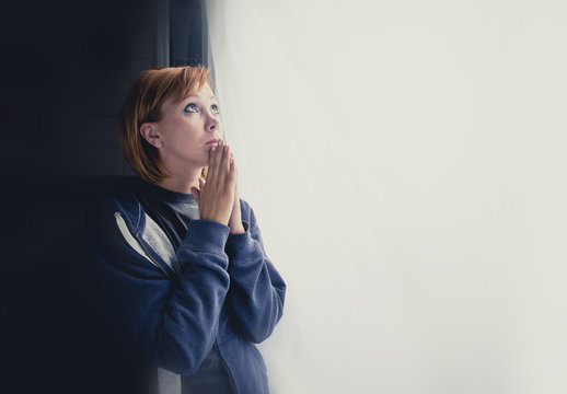 attractive woman suffering depression saying a prayer to god