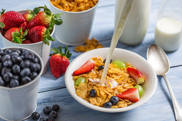 Cornflakes with fruits flooded with milk
