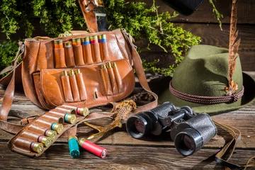 Gordijnen Bag, bullets and hat in a hunting lodge © shaiith