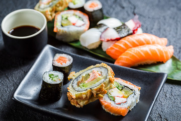 Fresh sushi on the black ceramic dish