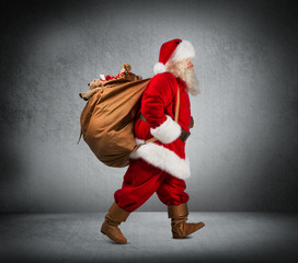 Santa Claus walking with the bag of the presents