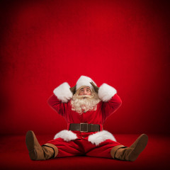 Santa Claus sitting on floor and looks frustrated