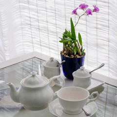Ceramic utensils on table with flower decoration