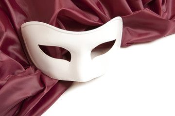 White theatrical mask and silk fabric