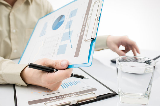 Close-up of graphs and charts analyzed by businessman