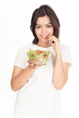 Pretty girl eating fresh vegetable salad