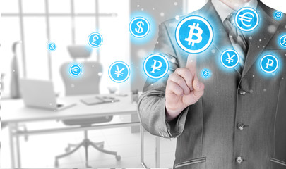 Choosing bitcoins, businessman pressing touch screen button.