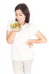 Pretty girl eating fresh vegetable salad