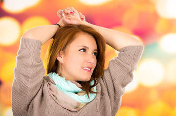 Portrait beautiful young blond girl over colorful background