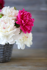 maroon and white peonies in a vase
