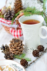 Obraz na płótnie Canvas Christmas composition with a cup of tea and fir cones