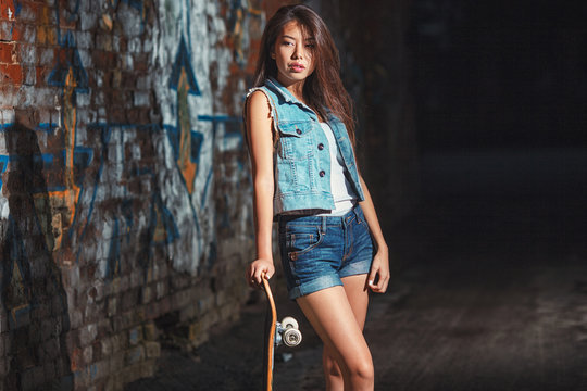 teen girl with skate board. Outdoors, urban lifestyle.