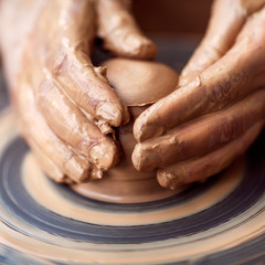 Obraz na płótnie Canvas Hands working on pottery wheel