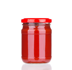 Glass jar full of tomato sauce.