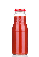 Glass bottle full of tomato juice.