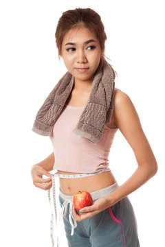 Asian healthy girl with apple measuring her waist