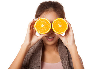 Asian healthy workout girl put orange over her eyes
