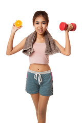 Asian healthy workout girl with orange and dumbbell