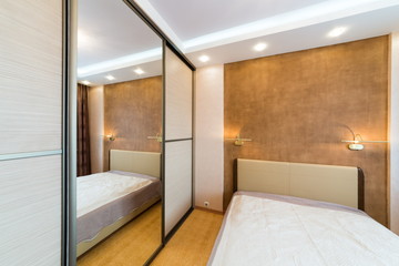 Modern bedroom with closet and large mirror