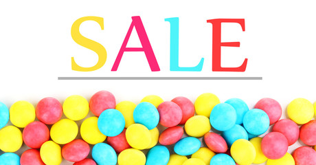 Sale concept. Color candies isolated on white