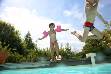 Kids jumping in swimming-pool