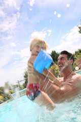 Father and son playing in swimming pool