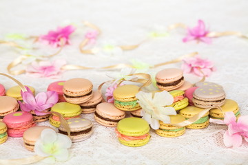 Colorful cookies with cream on table with flowers