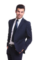 business man looking at you, holding his hands in pocket