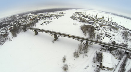 Aerial view to highway bridge over the frozen river