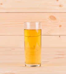 Apple juice on wooden table.